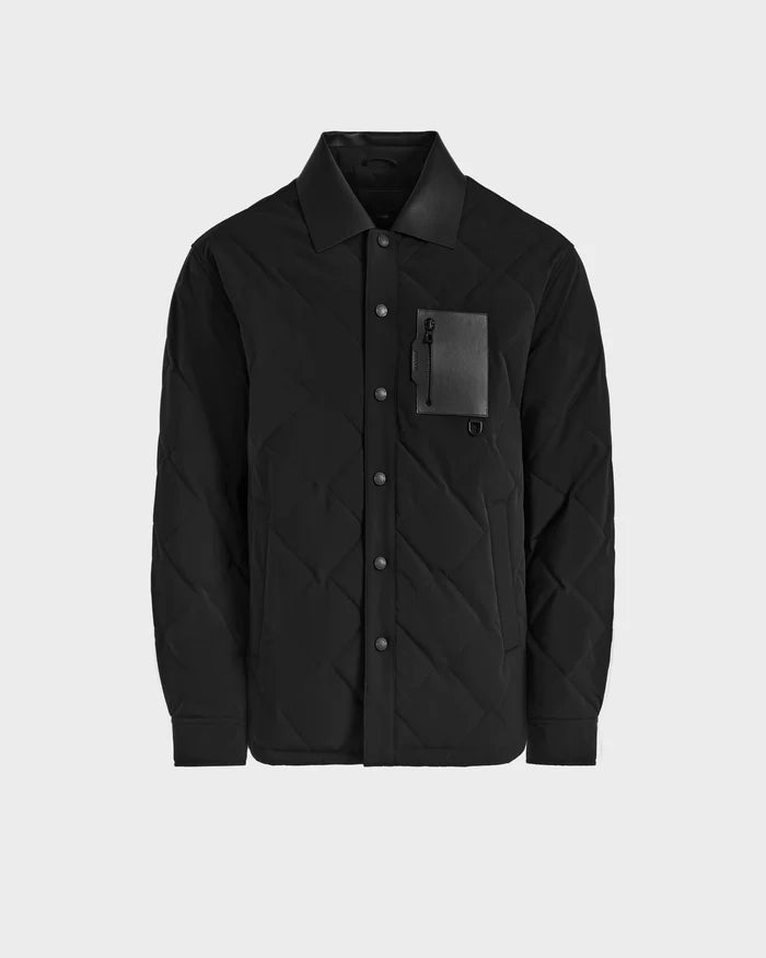 The Rudsak RYAN - 6125023 Black is a mens black quilted jacket with a pointed collar, snap front, zippered chest pocket with flap, eco-friendly insulation, and a minimalist design without visible branding.
