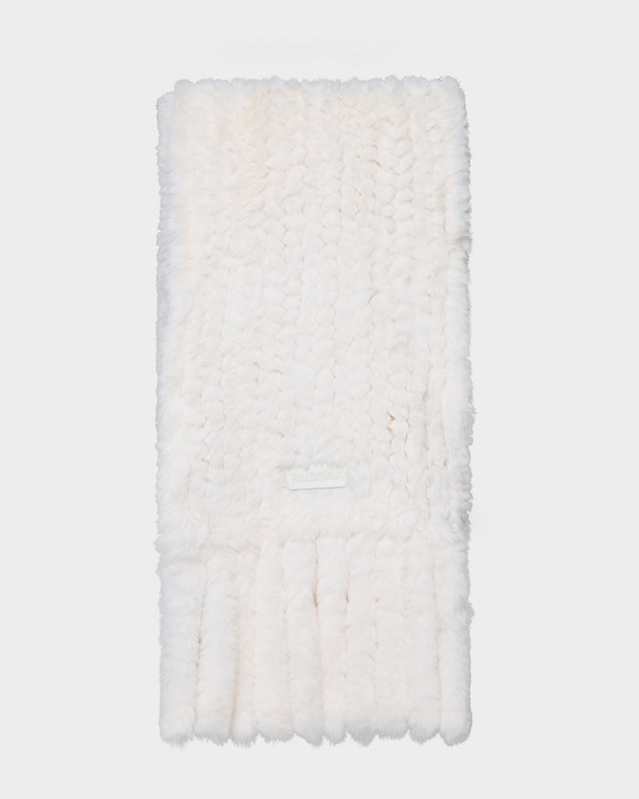 A folded, fluffy TAVIA - 8426511 Vanilla knit scarf by Rudsak, featuring a soft white texture and a patch label, displayed against a plain white background.