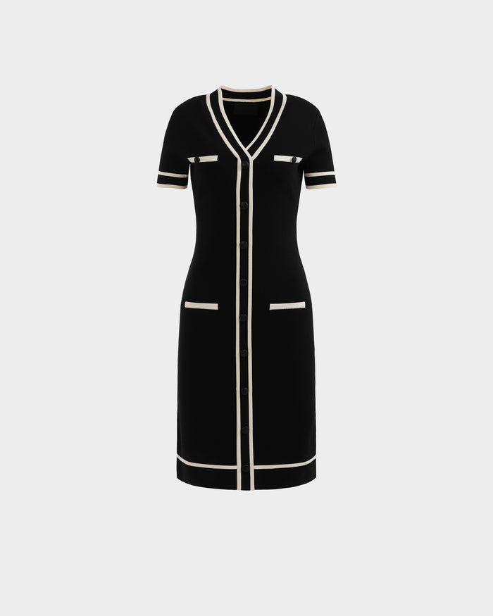 The VINNIE - 8526038 Black by Rudsak is a knee-length, short-sleeved black knit midi dress with white trim, V-neckline, front buttons, and four white-edged pockets—two chest and two hip—shown on a plain white background.