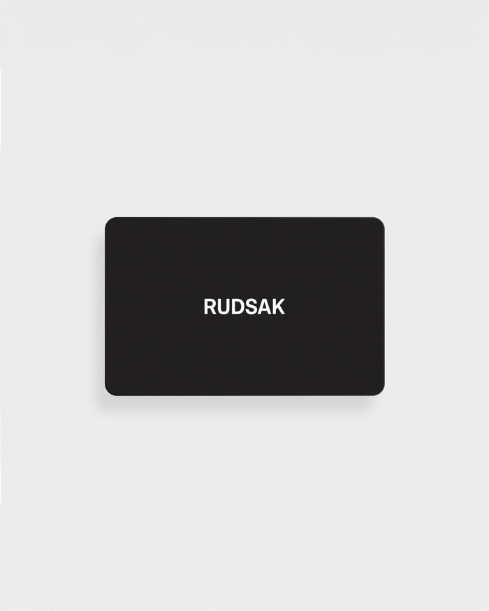 A black rectangular VIRTUAL GIFT CARD by Rudsak International features the white "RUDSAK" logo, centered on a plain white background. Enjoy email delivery and no expiration for maximum convenience.