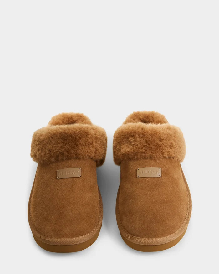 The Rudsak WILBER - 6225509 Tan are brown suede slippers with faux shearling-lined cuffs and rubber soles, shown side by side on a white background.