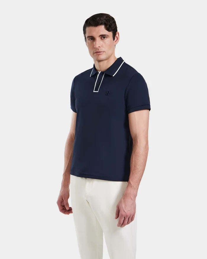 A man in a navy XAVIER - 6524027 polo shirt by Rudsak.