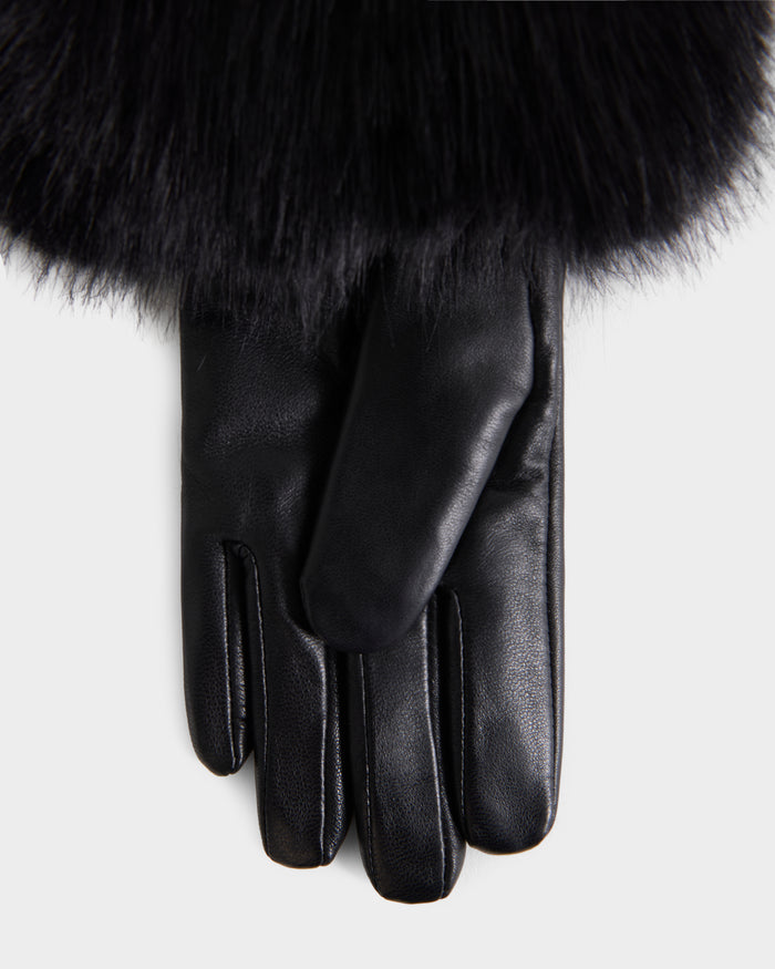 A close-up of the Rudsak ZAYLA - 8426712 Black leather glove, featuring a fluffy black fur cuff, shown against a plain white background.