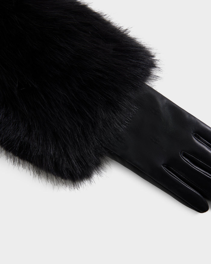A close-up of the Rudsak ZAYLA - 8426712 Black leather glove, featuring a thick black fur cuff, displayed on a white background.