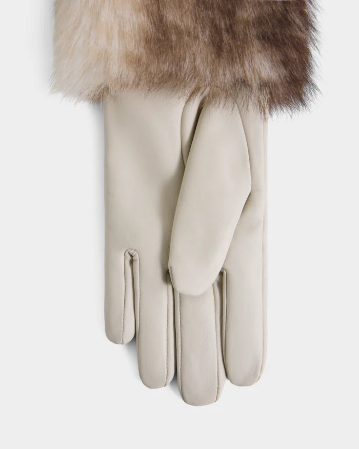 A pair of Rudsak ZAYLA - 8426712 Vanilla beige leather gloves lies flat on a white background, partially covered at the top by a piece of fur in brown, gray, and white tones.