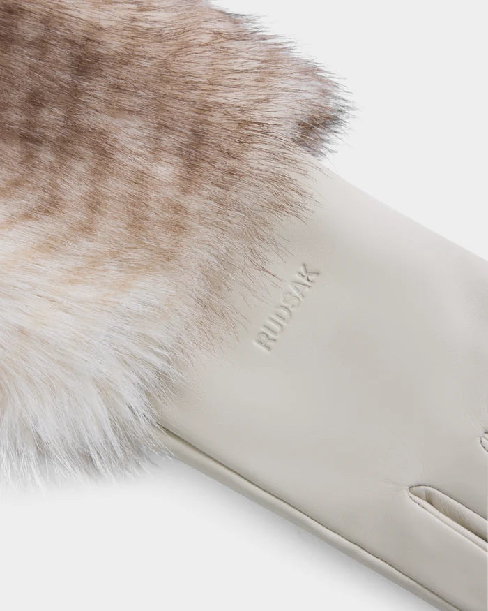 A close-up of the ZAYLA - 8426712 Vanilla glove by Rudsak, featuring beige leather with brown and white fur trim. The brand name “RUDSAK” is embossed on the leather near the wrist.