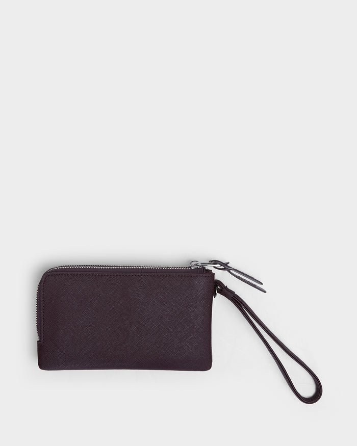 The ZURIE - L424501 Wine by Rudsak is a small, rectangular women’s wristlet wallet in black leather with zippered compartments and a matching wrist strap, shown on a plain white background.